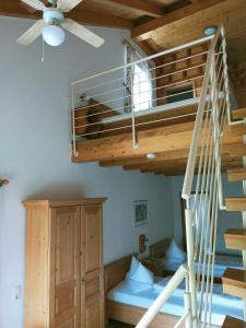 a room with a bunk bed and a spiral staircase at Landgasthaus Zum Erlengrund in Emskirchen