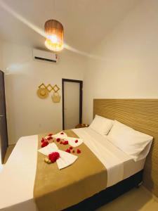 Un dormitorio con una cama con flores. en Casa - villa luisa a 100m do mar, en Paripueira