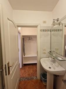 a bathroom with a sink and a bath tub at Residence Degli Agrumi in Taormina