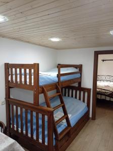 two bunk beds in a room with a wooden ceiling at Dusheti Rose in Dushetʼi