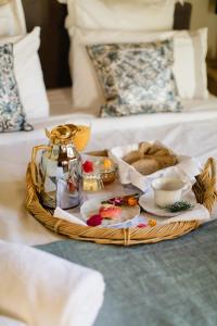 a tray of food on top of a bed at Suites at the Villas by Quinta da Bella Vista in Sintra