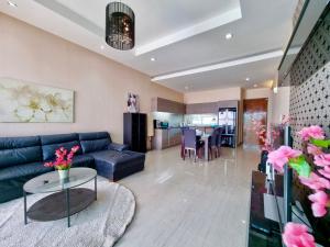 a living room with a blue couch and a table at ChinJu PoolVilla in Jomtien Beach