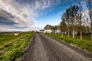 an empty road in front of a house at Guesthouse Bitra B&B in Selfoss