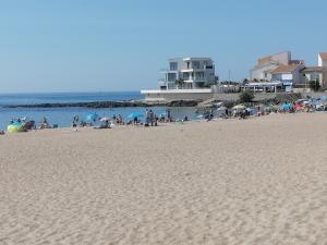 a group of people on a beach near the water at plage du Môle in Cap d'Agde