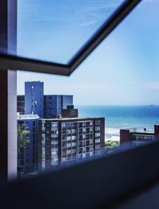 a view of the ocean from a balcony at Oceanic Unit 122 - Durban North Beach in Durban