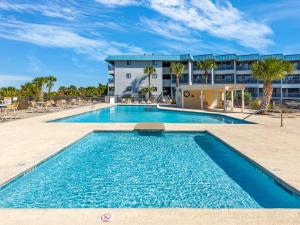 a swimming pool in front of a building at Beach Racquet A127 in Tybee Island