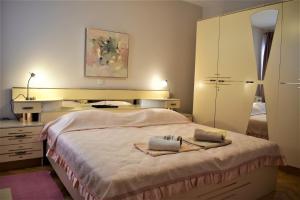a bedroom with a bed with two towels on it at Apartments Panorama view Zeljko Scerbe in Rab