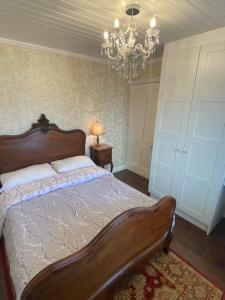 1 dormitorio con cama y lámpara de araña en NEW LISTING Faye’s Place, en Donegal