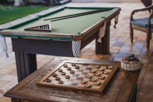 a pool table with a chessboard on a table at Oka Da Mata in Pipa