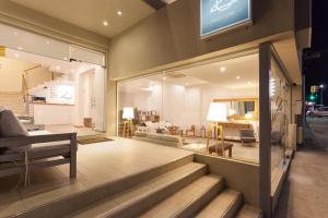 a store front with a staircase leading to a living room at 20 Hotel in Punta del Este