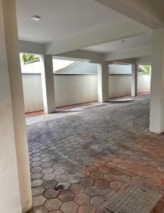 an empty room with a stone floor and white columns at Bamburi 2 bedroom Luxury homes in Bamburi