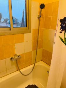 a bathroom with a shower with a bath tub at Résidence Karamel Yaoundé Anguissa in Yaoundé