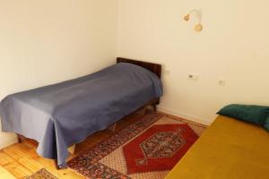 a corner of a room with a bed and a rug at Your villa with garden in Martuni next to Sevan lake in Martuni