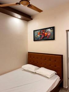 a bedroom with a bed with a painting on the wall at Izi Airport Stay in Chennai