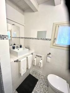a white bathroom with a sink and a toilet at RESIDENZA SERENA B&B - Centro Storico in Mantova