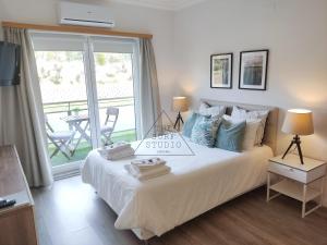 a bedroom with a bed with a sign on it at The Surf Studio - Ericeira in Ericeira +37 photos