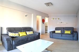 salon z dwiema kanapami i stołem w obiekcie Appartement cœur de juan les pins w mieście Antibes