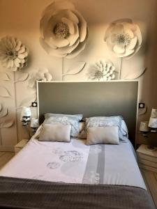 a bedroom with a bed with flowers on the wall at Logis de Mélisandre in Vaux-sur-Mer