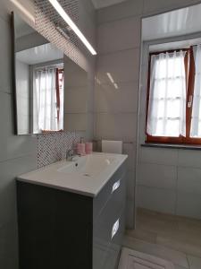 a bathroom with a sink and a mirror at Miragaia Star Apartments in Angra do Heroísmo