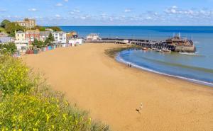 a view of a beach with a pier and the ocean at Fagin's Den in Broadstairs - Winter special offers! in Broadstairs