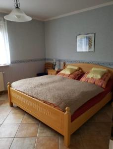 a bedroom with a large bed in a room at Wanderoase Ibental in Asbach