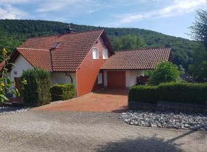 a house with a red roof and a driveway at Wanderoase Ibental in Asbach