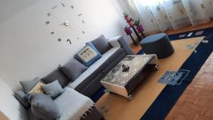 a living room with a couch and a table at Apartman Radovic in Pale