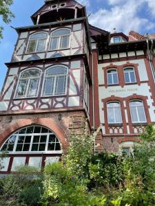 a tall building with a clock tower on top of it at Helsinki Apartment Erfurt 1 in Erfurt