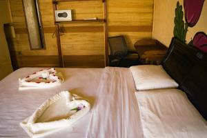 Voodi või voodid majutusasutuse Essence Arenal Spa & Yoga toas