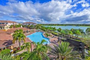 an aerial view of a resort with a pool and a lake at Brand New Modern Vista Cay Reserve Condo - 5003 in Orlando