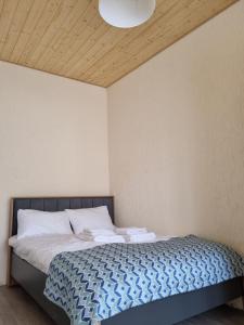 a bedroom with a bed with two towels on it at Greenfield Bakuriani in Bakuriani