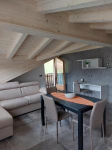 a dining room with a table and a couch at Lucas Haus in Livigno