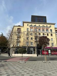 a large building with a sign on the top of it at Bright apartment in front of Vake Square in Tbilisi City