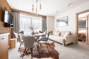 a living room with a couch and a table and chairs at Apartament LUNA APARTZAKOP in Zakopane