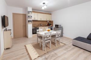 a living room with a table and a kitchen at Ioama Island in Burgas City