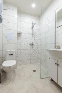 a bathroom with a shower and a toilet and a sink at Ioama Island in Burgas City
