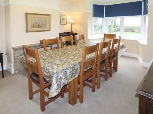 a dining room with a table with chairs and a table and a table and chairs at Moor House in Tirril