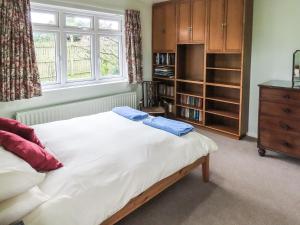 a bedroom with a large bed and a window at Moor House in Tirril