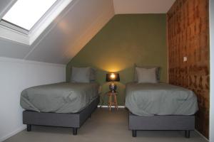 Een bed of bedden in een kamer bij B&B Ossegang