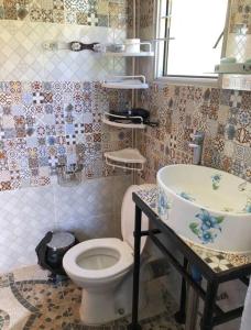 a bathroom with a toilet and a sink at Altos de Curacavi in Curacaví