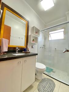 a bathroom with a toilet and a sink and a shower at Apto POTY- 4 Pessoas - Ótima localização - 150 m do mar in Capão da Canoa