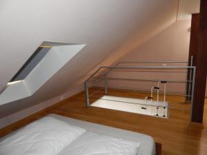 a bed in a room with a stair case at Apartament Giżycko in Giżycko