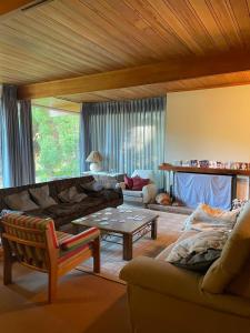 Hosteria La Chacra في إيسكيل: غرفة معيشة مع أريكة وطاولة