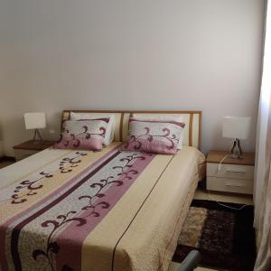 a bedroom with two beds with pink pillows at Prothea Home in Vila Chã