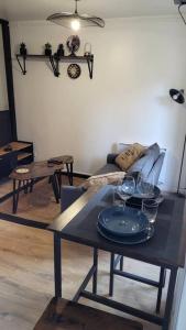 a living room with a table with wine glasses on it at Studio cosy Saint-Étienne centre ville in Saint-Étienne