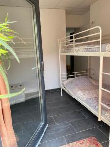 a room with two bunk beds and a mirror at Rez-de-villa proche de la mer - Villa Temana in Saint-Cyr-sur-Mer