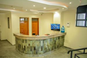 a lobby with a reception counter with a window at Vee’s Rustic Studio, Nakuru Town. in Nakuru
