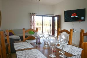 a dining room table with wine glasses on it at Casa Livia Pool & Sunset in Corralejo