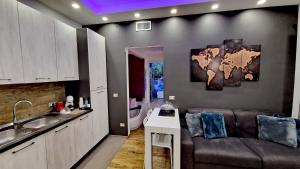 a kitchen with a couch and a map on the wall at Baby Suite in Alberobello