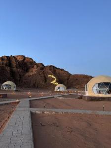 a view of a desert with a mountain in the background at Amanda Luxury Camp in Wadi Rum